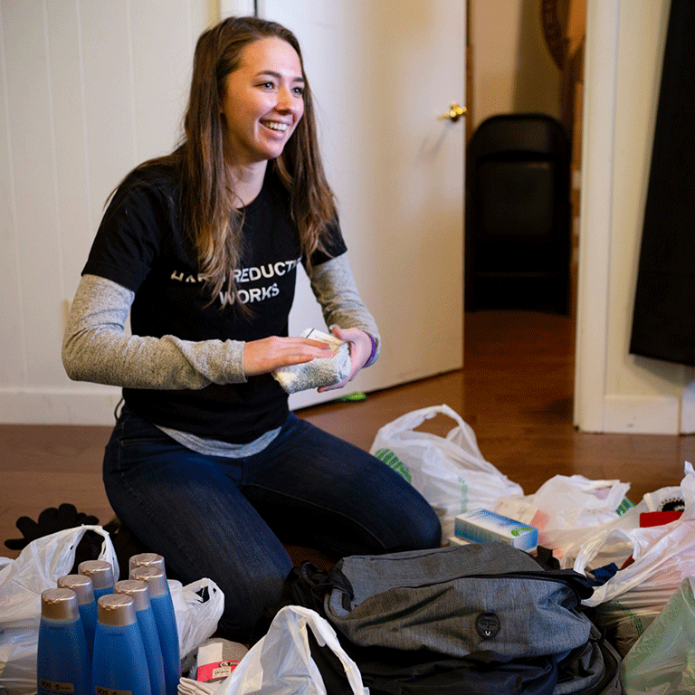 Arielle Hacker, social work student, assembling kits for Indiana Recovery Alliance.